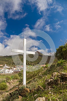 White wooden cross standing on hill