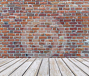 White wooden deck floor with red brick background