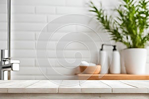White wooden deck table, on a blurred bathroom background.