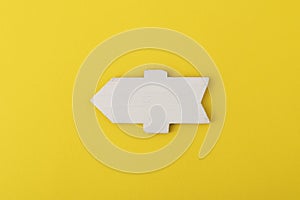 White wooden direction sign on yellow background. Direction Signs. Copy space. Mock up