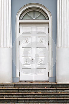 White wooden door with an arch.