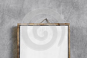White wooden empty board hanging on gray concrete cement wall. Place for logo