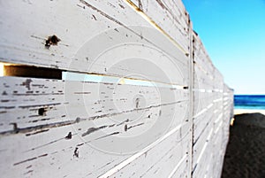 A white wooden fence on the beach