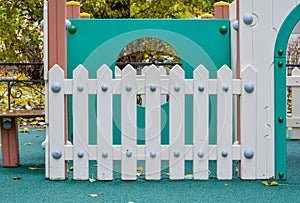 White wooden fence boards on children playground. Fun playground with fence