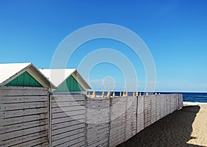 A white wooden fence with some booths