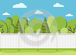 White wooden fence with trees. Modern rural white fence with green grass