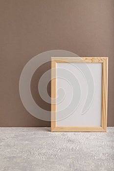 White wooden frame mockup on beige paper background. Blank, vertical orientation, copy space