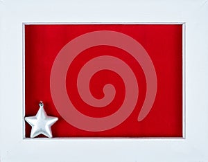 White wooden frame and a star over a red background