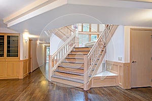 White wooden hallway interior accented with a beautiful staircase