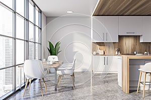 White and wooden kitchen with dining table