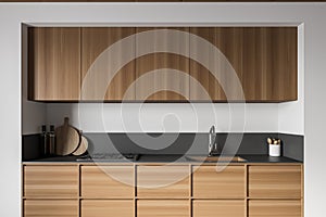 White and wooden kitchen interior with cupboards, close up