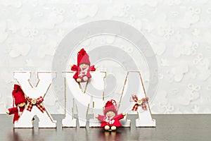 White wooden letters on brown wooden table forming word XMAS wit