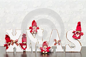 White wooden letters on brown wooden table forming word XMAS wit