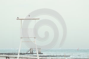 A white wooden lookout lifeguard tower.