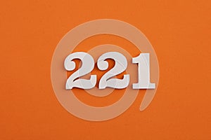 White wooden number 221 on eva rubber orange background