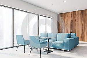 White and wooden office lounge corner, blue sofas