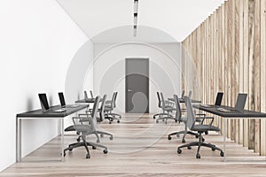 White and wooden open space office with door