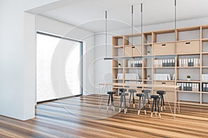 White and wooden room with chairs and bookshelf with books, parquet floor