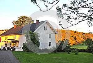 White wooden scandinavian house on sunset