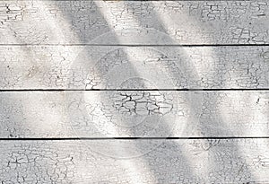 White wooden shabby rustic weathered desk planks with sunlight cracked paint