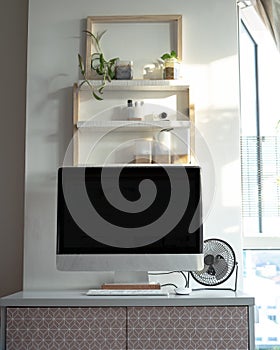 White and wooden shelves furniture and in stylish a room. Dapple light during sunrise. Scandinavian modern korean style
