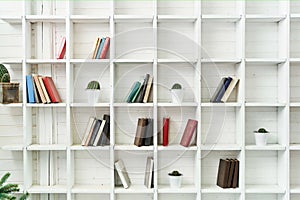 White wooden shelves with old books. Wooden bookcase.
