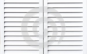 White wooden shutters to protect windows from sunlight