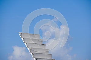 White wooden stair on sky background