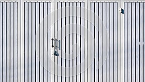 White wooden and steel folding entrance gate door background with hasp and stainless steel door handle