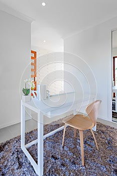 White wooden table and light wooden chair in the modern room