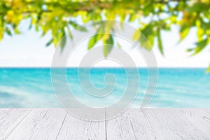 White wooden table top at ocean beach background. 2020 island vacation concept with copy space