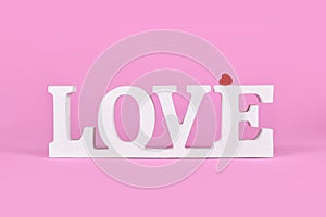White wooden word LOVE with red heart