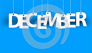 White word DECEMBER - word hanging on the ropes on blue background. New year illustration.