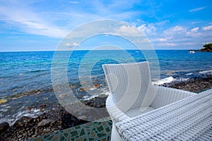 White woven chait and table at beach