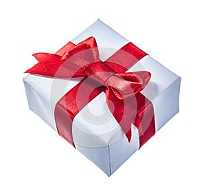 White wrapped present box with red knot isolated on white