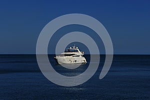 White yacht in the Black Sea, lit by the moon.