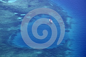 White yacht coral reef in beautiful bay sea. Aerial view.