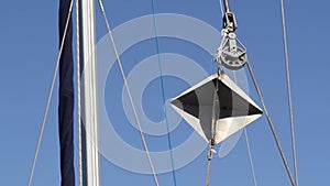 White yacht cordage ropes swaying in the wind over blue sky, close up video