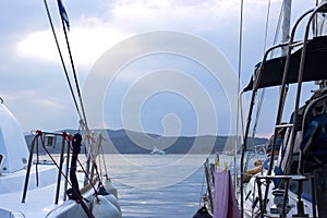 White yacht docked in marina, with sky in the background; with copy space