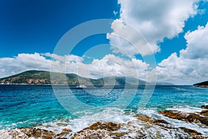 White yacht drift in middle of open crystal clear emerald green sea water near Fiskardo town. Ithaki Island in