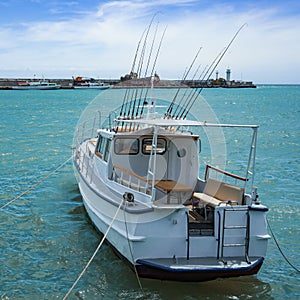 White yacht with fishing rods on the background of the seascape