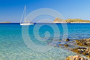 White yacht on the idyllic beach lagoon of Crete