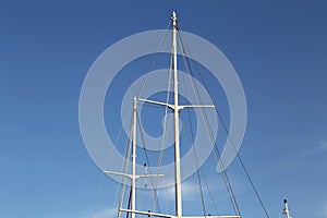 White yacht masts against the blue sky