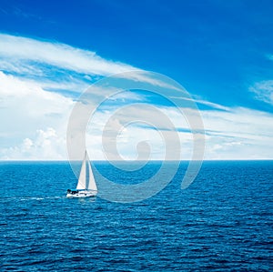 White Yacht Sailing in Blue Sea.