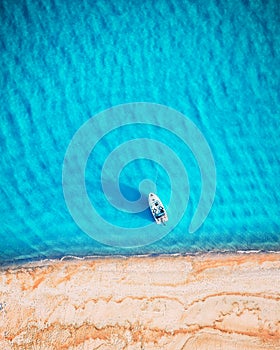 White yacht and turquoise water waves from top view