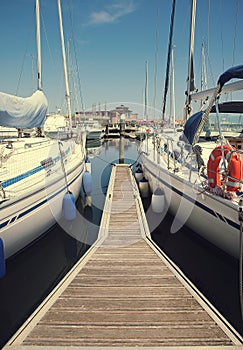 White yachts in the port waiting. On the sea is calm.