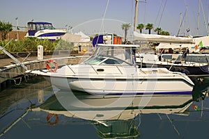 White yachts in the port waiting. On the sea is calm.