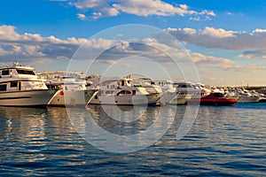 White yachts in sea harbor of Hurghada, Egypt. Port with tourist boats on the Red Sea