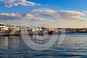 White yachts in the sea harbor of Hurghada, Egypt. Port with tourist boats on the Red Sea