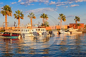 White yachts in the sea harbor of Hurghada, Egypt. Port with tourist boats on the Red Sea